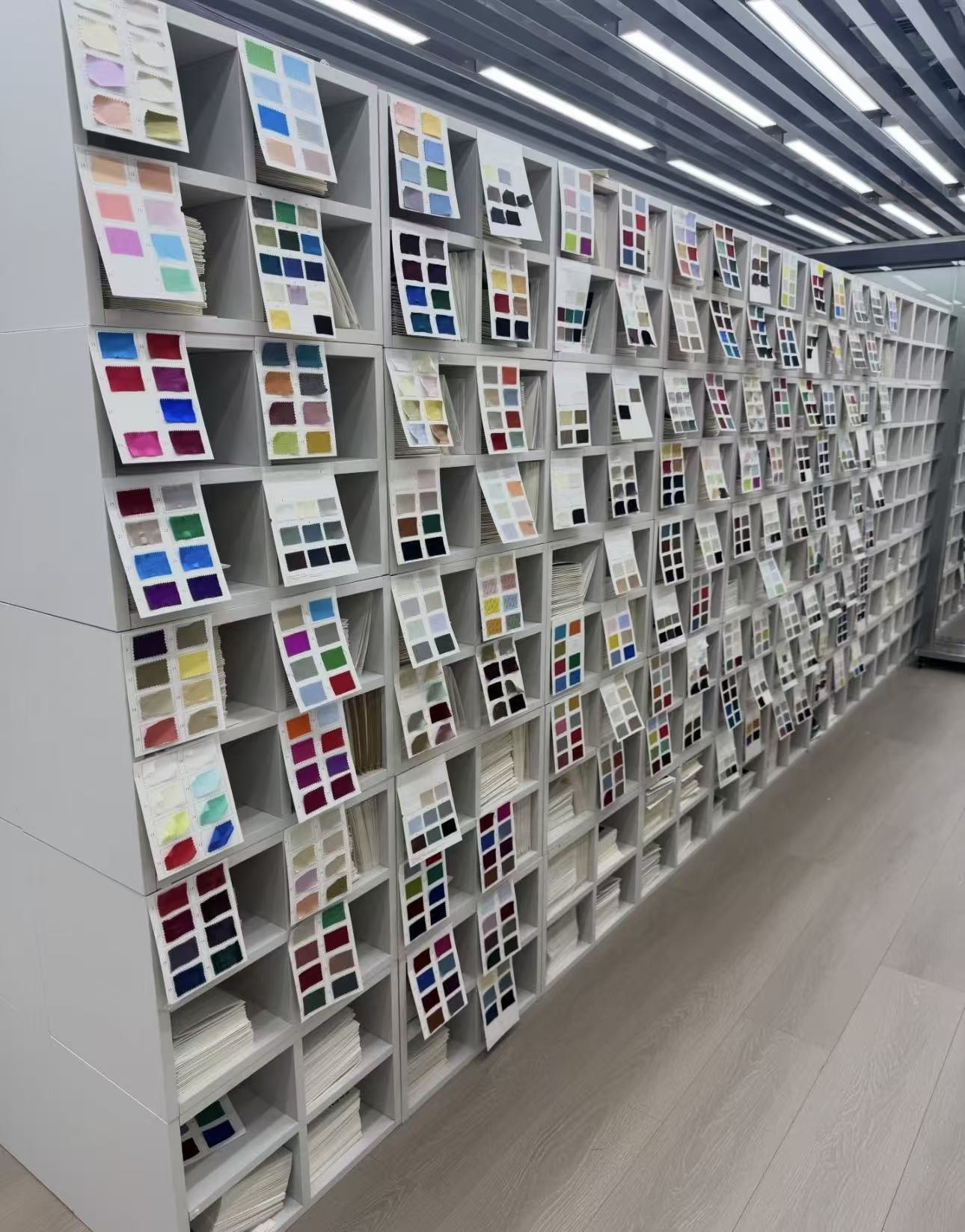 Hundreds of fabric colour cards on the wall — you choose, we make