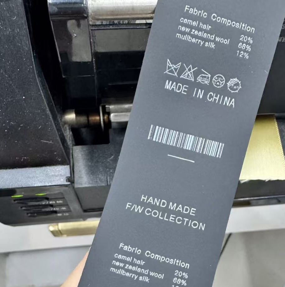 Woven care label with branding details on a finished garment