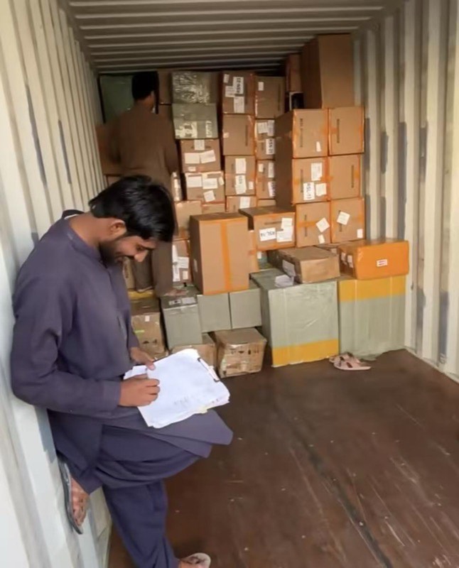 Worker checking documents inside a container