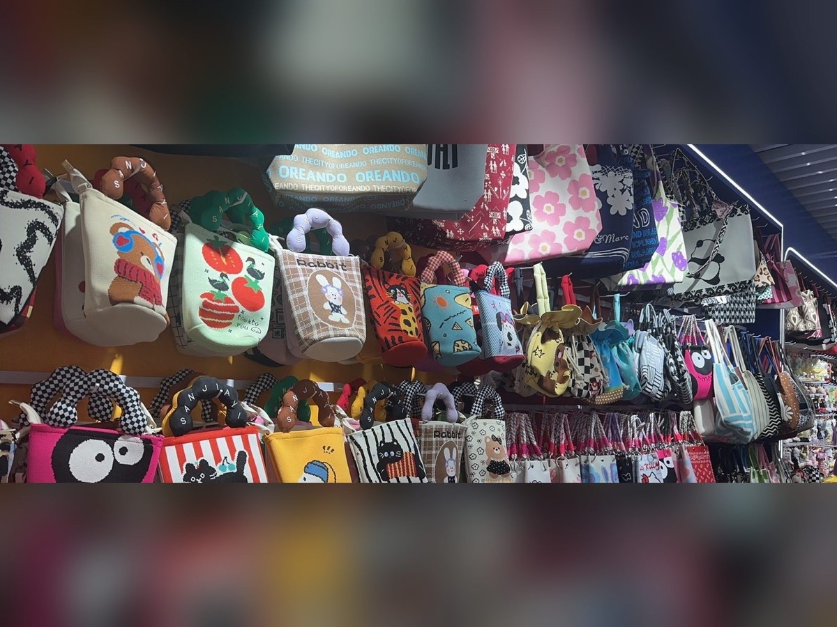 Wall of knitted tote bags at Yiwu accessories wholesale market