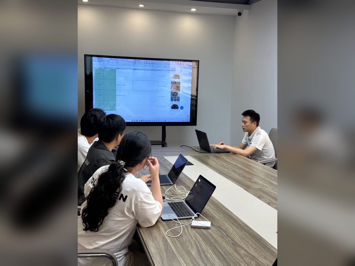 Team building a landed-cost quotation for a client with product photos and prices on screen