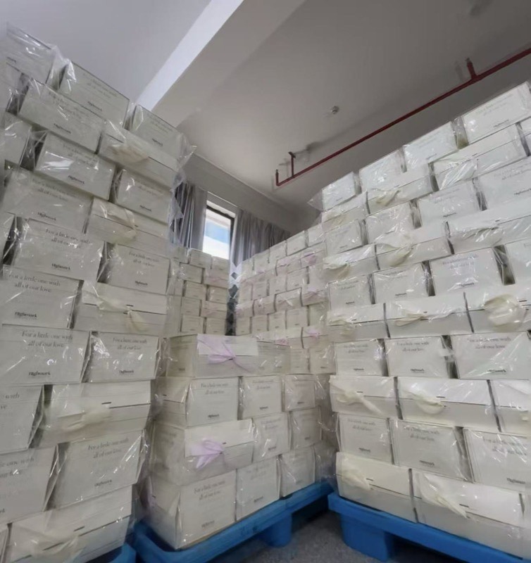White gift boxes stacked in warehouse